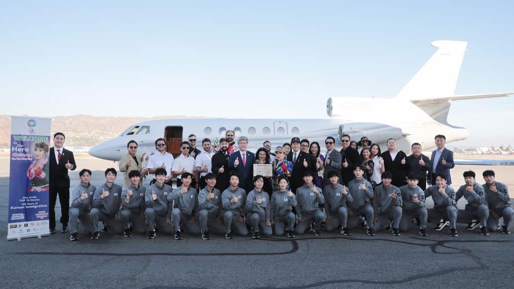 group photo in front of private jet